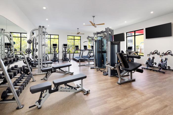 Bright resort fitness center equipped with Matrix treadmills, free weights, and stationary bikes
