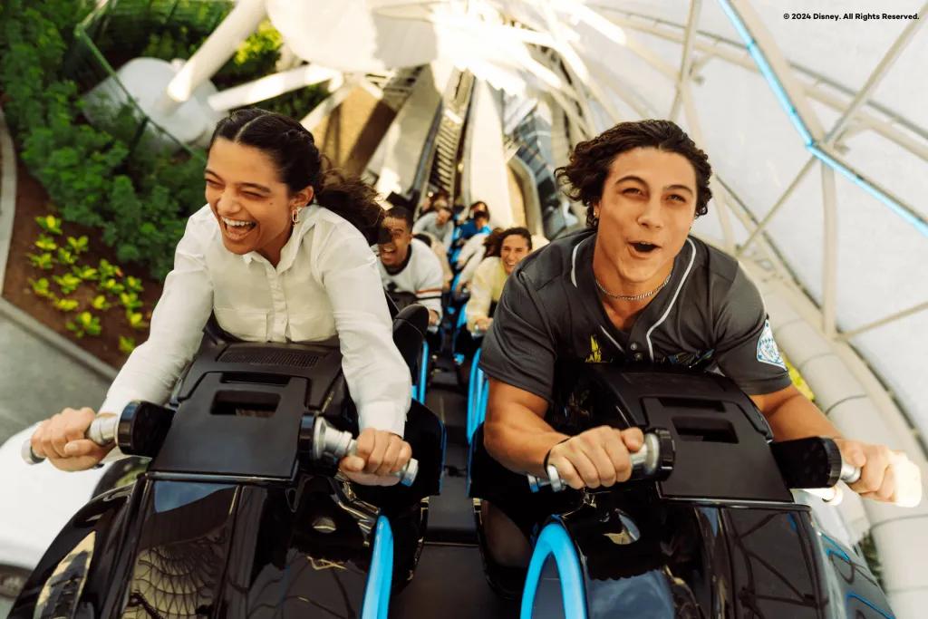 Two adults on a motorcycle-shaped ride vehicle on a rollercoaster