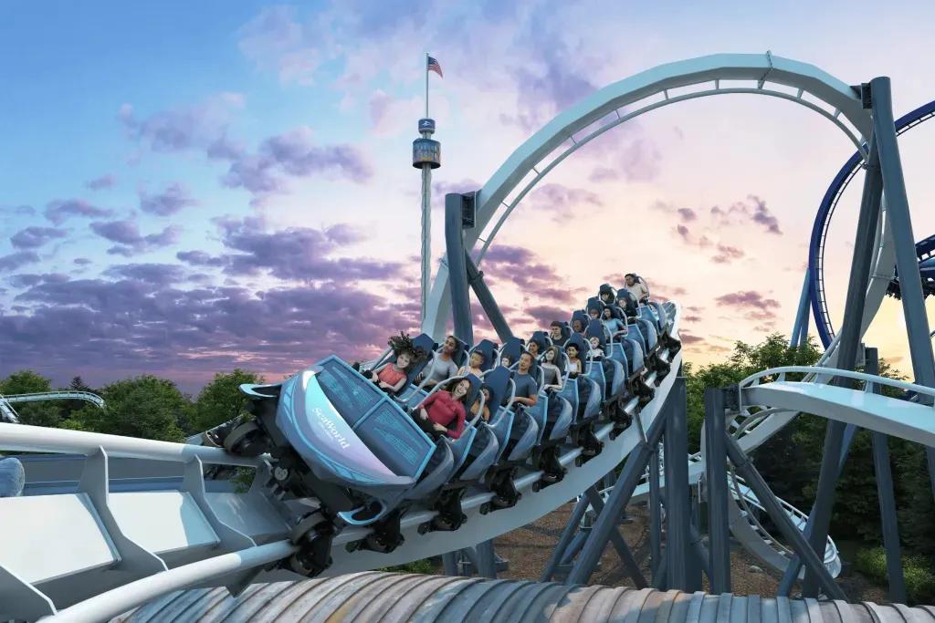 Grafik einer eisblauen Familienachterbahn, auf der viele lächelnde Menschen sitzen, während sie sich um die Kurven schlängelt. Im Hintergrund geht die Sonne in rosafarbenen und blauen Tönen unter.  