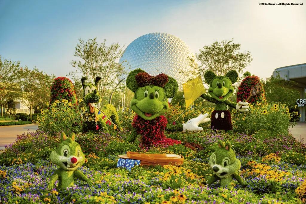 Topiaries shaped like Mickey Mouse, Minnie Mouse, Pluto, Chip and Dale in front of Spaceship Earth in EPCOT