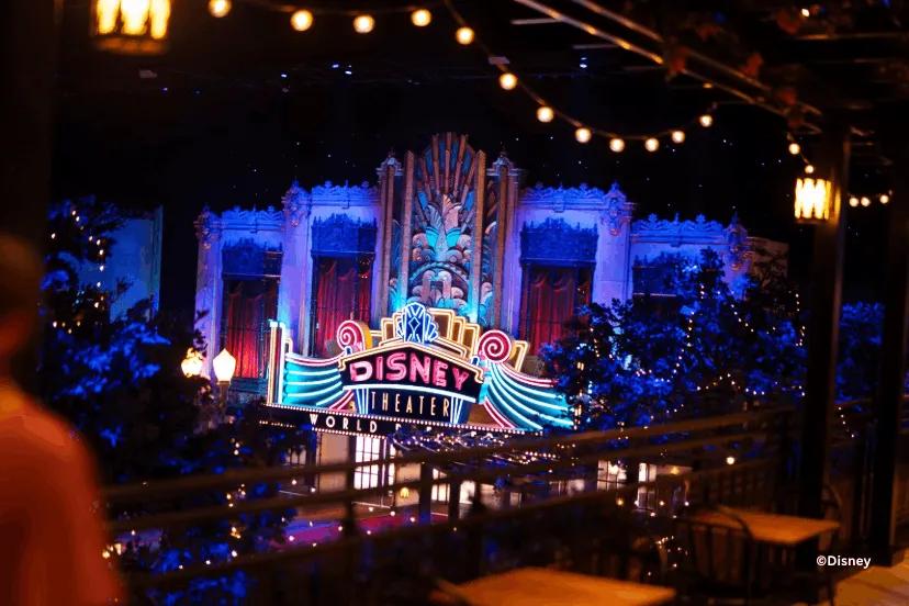 The vibrant neon "Disney Theater" marquee at World Premiere