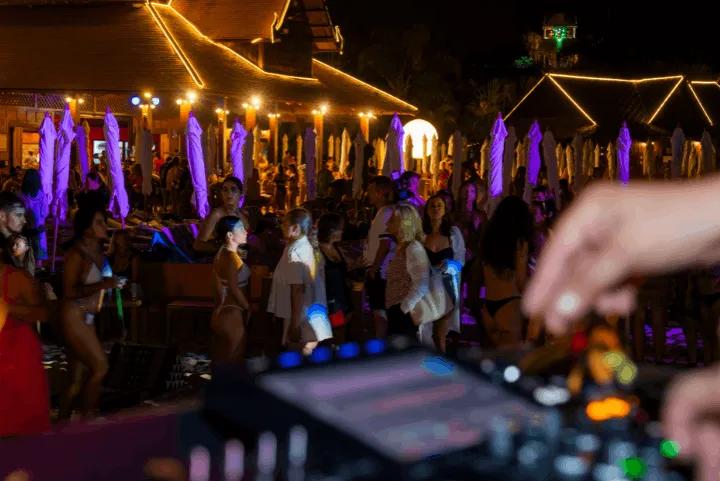 A group of people in front of a DJ set during Siam Night