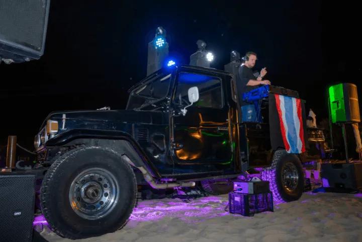 A DJ in the back of a jeep at Siam Night