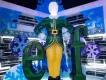 Sign of green letters saying elf in font from movie but instead of an L there is an ice sculpture of Buddy the Elf stood up straight wearing a dark green elf suit.
