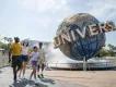 A family walking in front of the Universal globe at Universal Orlando Resort
