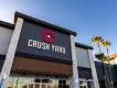 A building which looks new and modern with a sign saying Crush on it and a paddleboard logo. Yard