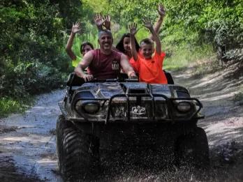 Adults and children having fun riding The Mucky Duck