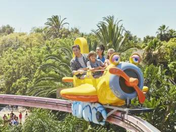 Family riding Coco Piloto at PortAventura theme park