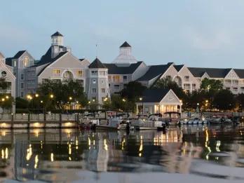 An elegant yacht club-inspired hotel on the edge of a boat-lined waterfront