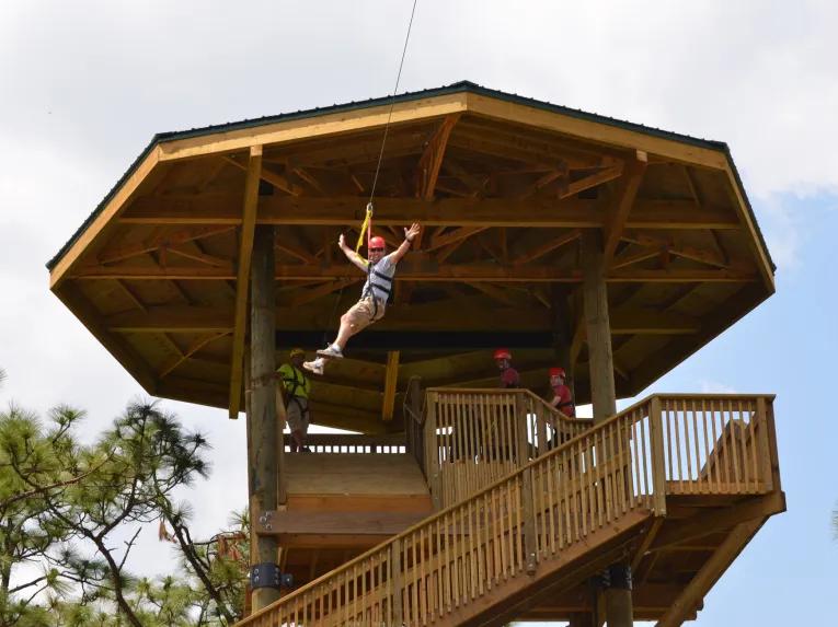 Guest riding the Screamin' Gator Zip Line at Gatorland Orlando