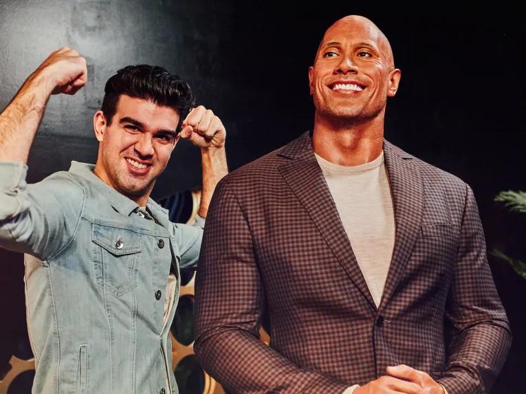 Guests posing with Dwayne Johnson at Madame Tussauds London