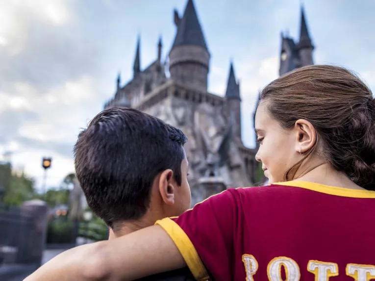 Siblings in front of Hogwarts Castle at Universal's Islands of Adventure