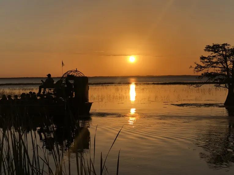 Guests enjoying a sunset airboat ride at Boggy Creek Orlando