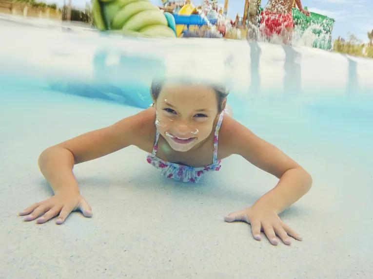 Girl swimming underwater at PortAventura Caribe Aquatic Park 