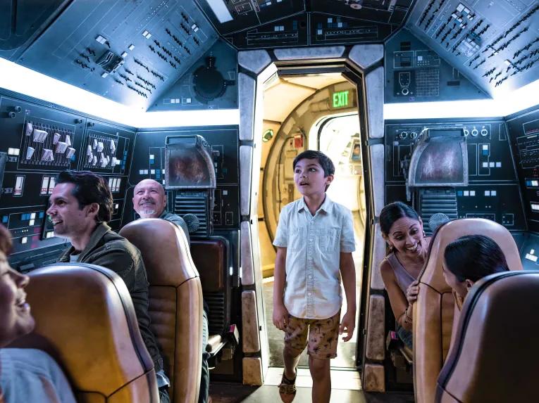 Boy in the Millenium Falcon cockpit, Star Wars: Galaxy’s Edge in Disneyland Park in California