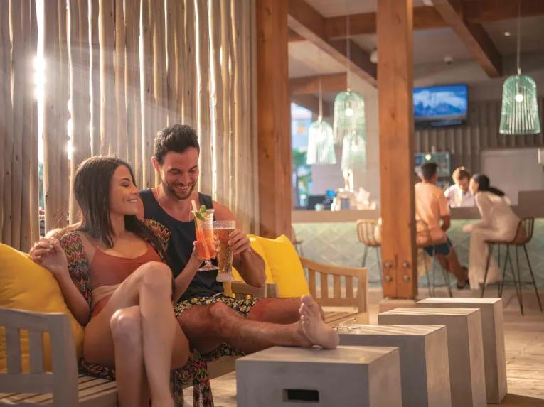 Couple enjoying a drink in the poolside bar,Universal's Endless Summer Resort - Dockside Inn and Suites