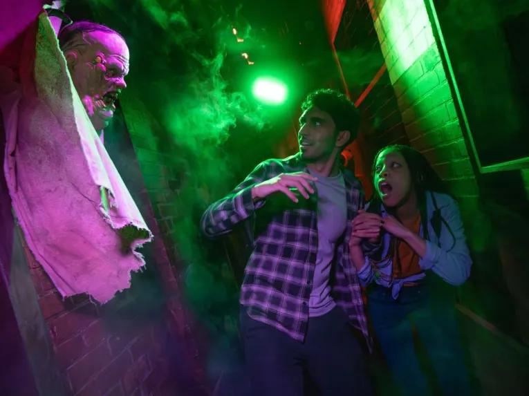 Guests in scare house at Universal Orlando Halloween Horror Nights