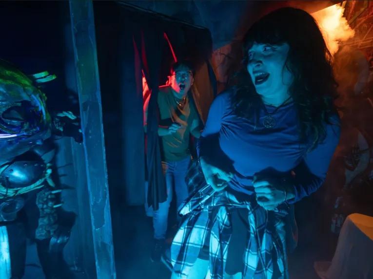 Guests in scare house at Universal Orlando Halloween Horror Nights