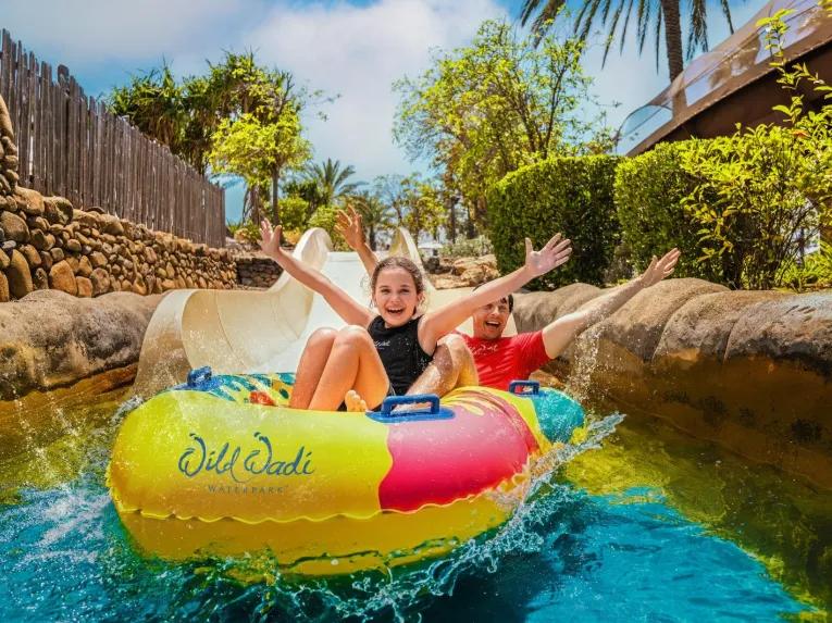 People smiling and enjoying a water ride at Wild Wadi Waterpark